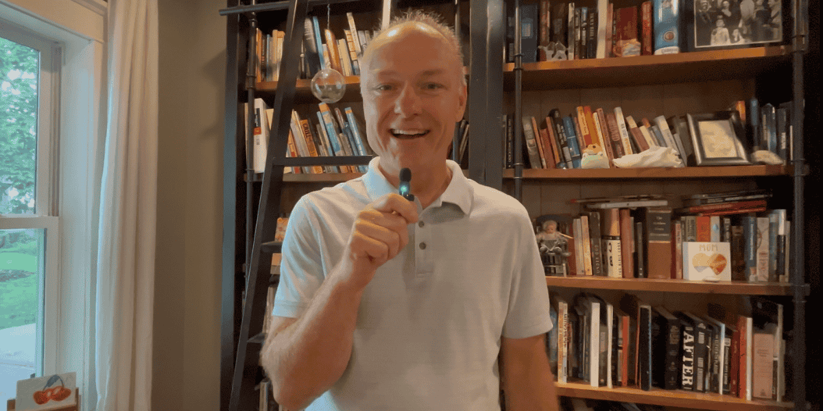 Man in front of bookshelf video
