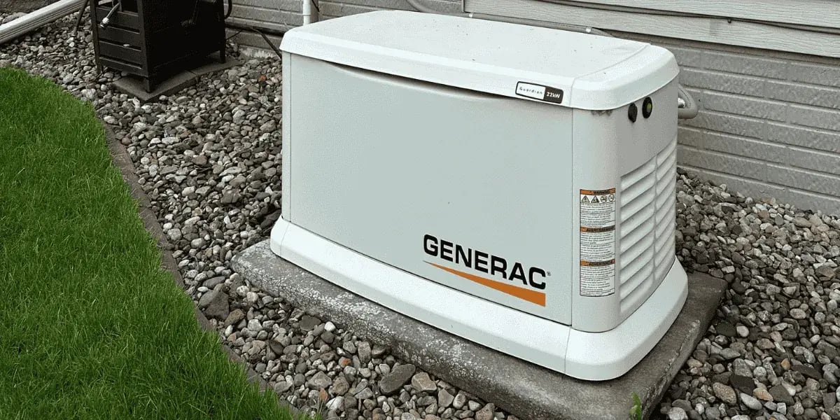 Generac standby generator installed by Integra Electrical outside a home in Clive, Iowa, with gas and electrical hookups mounted on a concrete pad.