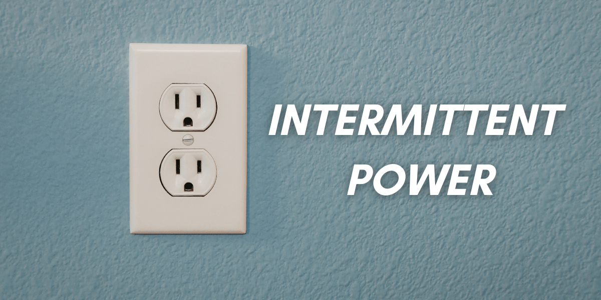 An outlet in a blue wall with the words 