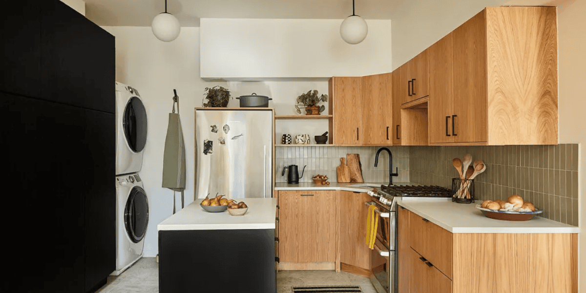 Modern kitchen and laundry space with refrigerator, oven, dishwasher, and stacked washer-dryer the biggest power hog appliances in a home