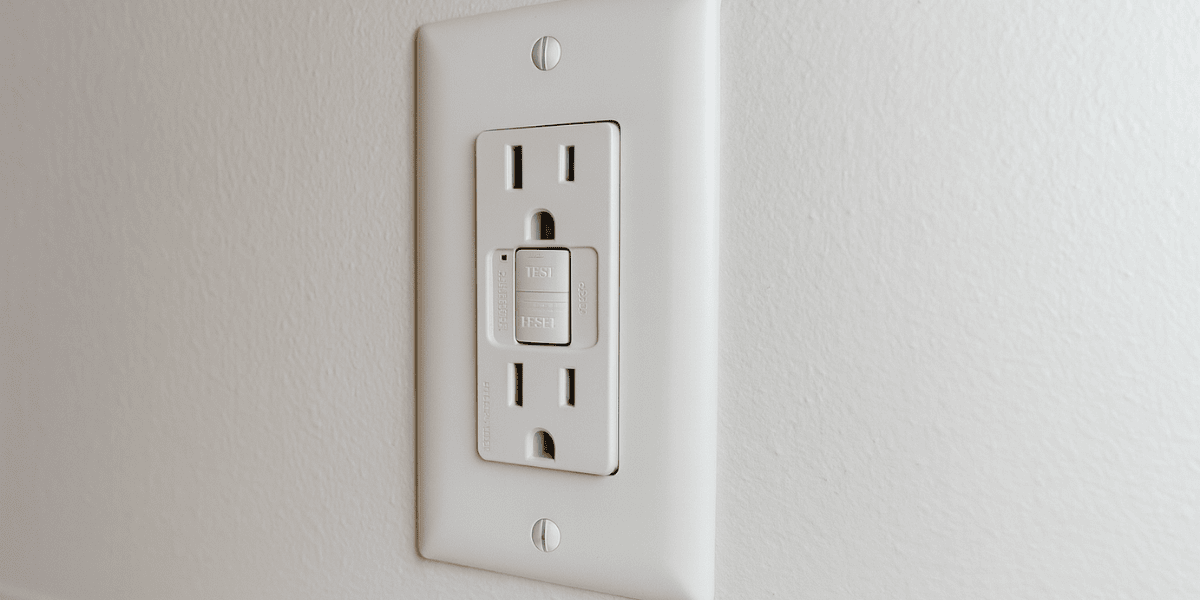 GFCI Outlet with white cover on white wall