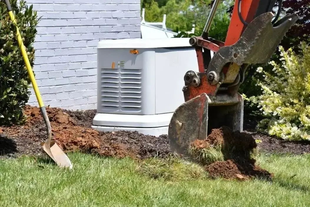 Excavator digging near a home’s standby generator during installation